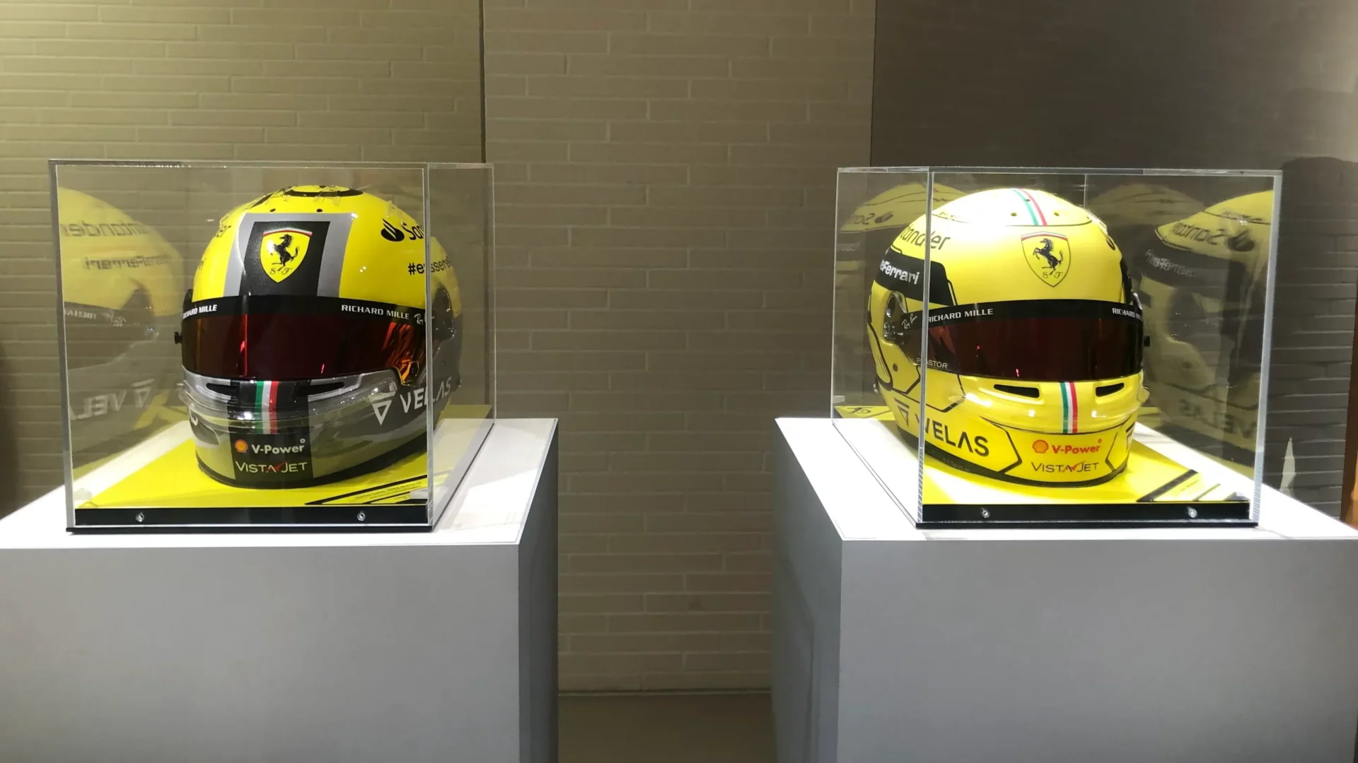 The helmets of Ferrari drivers, specially designed for the Italy weekend, on display at the Ferrari store in Milan before the race.